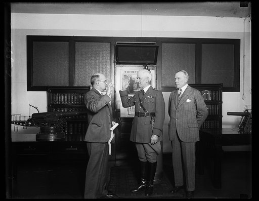 New Chief of the Coast Artillery sworn in. Major General John N. Gulick, center, who was sworn in today as Chief of the United States Coast Artillery. He succeeds Major General Andrew Hero Jr. Left to right, Captain Frank E. Taylor, of the Militia Bureau, General Gulick, and General Hero