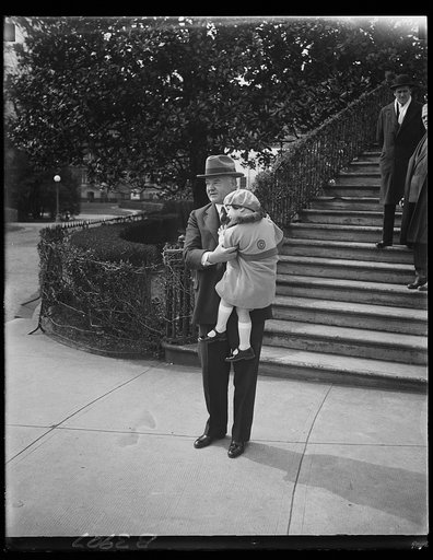 President Hoover receives first Buddy Poppy. Little Lois June Allen, five-year-old daughter of deceased veteran, presenting President Hoover with the first Buddy Poppy of the annual campaign conducted by the Veterans of Foreign Wars of the United States for the relief of disabled veterans and their 