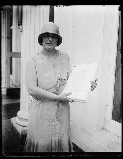 Woman at White House holding HR 2667, Public No. 361, 71st Congress, Approved June 17, 1930. Washington, D.C.