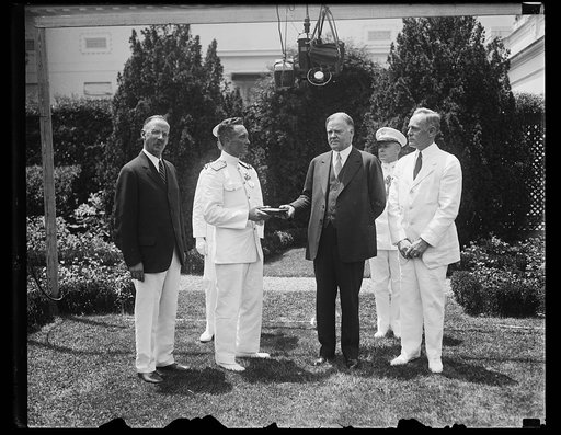 President Hoover presents special gold medal to Admiral Byrd. Rear Admiral Richard E. Byrd receiving from President Hoover the special gold of the National Geographic Society at the White House today. In the photograph, left to right; Gilbert Grosvener [i.e. Grosvenor], President of the National Geo