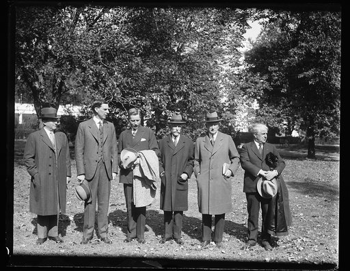 Group, left to right: unidentified, Ray Wilbur, unidentified, Andrew Mellon, unidentified, James J. Davis. White House, Washington, D.C.