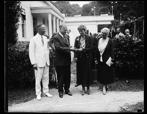 Herbert Hoover presenting the National Geographic Society medal to Amelia Earhart; with Dr. Gilbert Grosvenor, at left. White House, Washington, D.C.