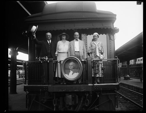Charles Curtis, left; on back of train