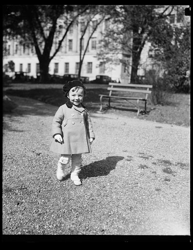 Child walking near park bench