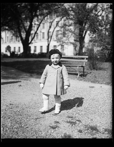 Child walking near park bench