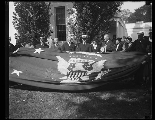 Herbert Hoover and group; with flag with U.S. seal, White House, Washington, D.C.