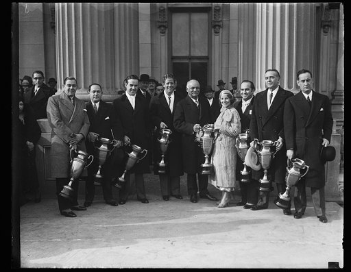 Charles Curtis and group holding trophy cups