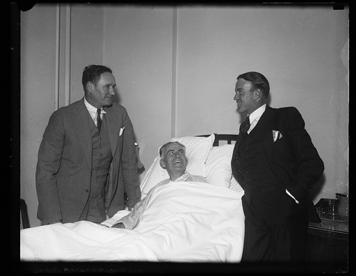 Joseph T. Robinson? left; with man in hospital bed