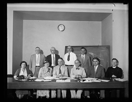 Group: includes, at table, Frances Perkins, 2nd from left, and John L. Lewis, 2nd from right