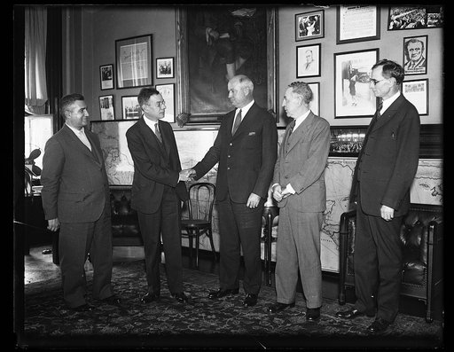 James A. Farley, center