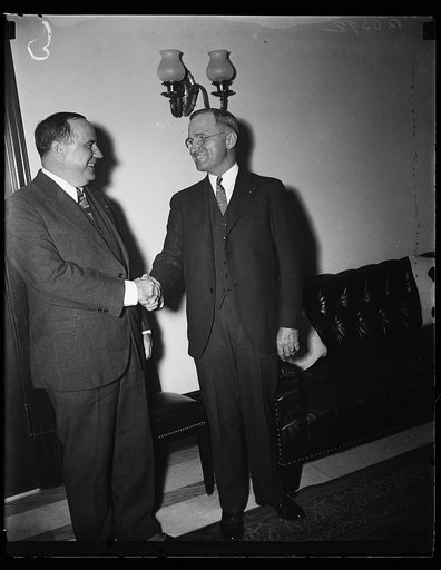 Senator Harry S. Truman (right) shaking hands with man