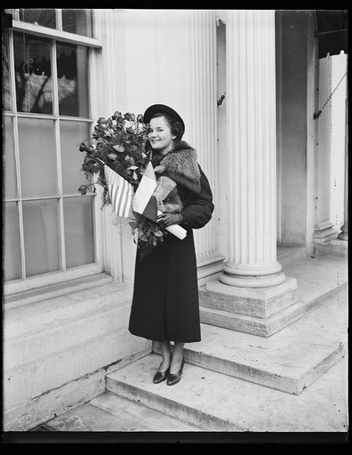 Woman with bouquet of flowers. White House, Washington, D.C.