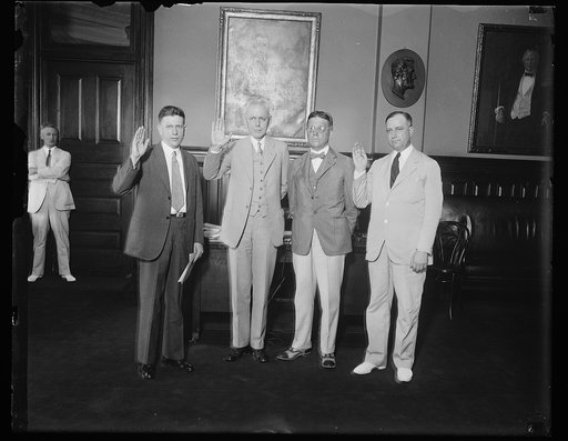 Administrative Assistant to Postmaster General and Assistant Postmaster General take oath of office at same time., Robert S. of Lancaster, Pa., beings sworn in as Administrative Assistant to Postmaster General Brown, and Frederic A. Tilton of Detroit, Mich., taking the oath of office as Thrid Assist
