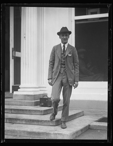 Man at White House; camera? on steps, Washington, D.C.
