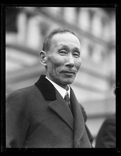 Man in front of State, War and Navy Building, Washington, D.C.
