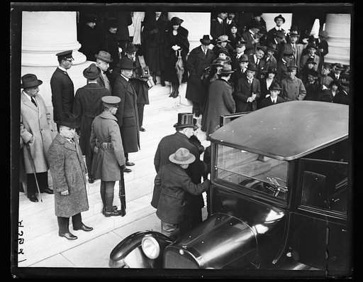 Group outside automobile; W.H. Taft, center