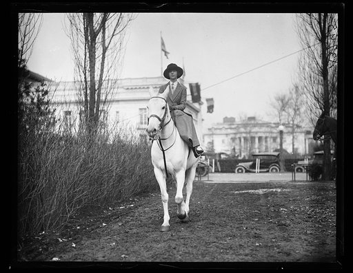 Woman on horseback. White House in background. Washington, D.C.