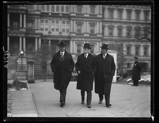Edwin Denby, Charles Evans Hughes, and John W. Weeks. State, War and Navy Building in background, Washington, D.C.