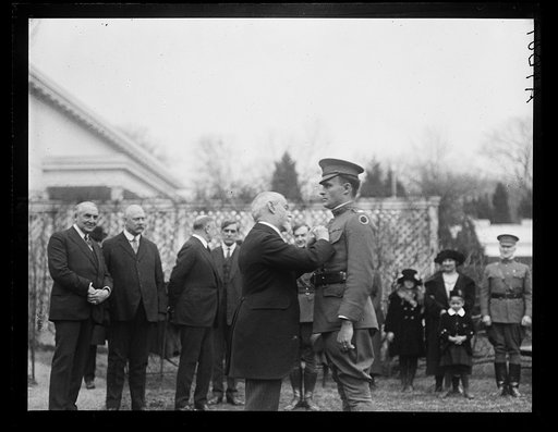 Wounded soldier receiving pin; Warren Harding at left. White House, Washington, D.C.