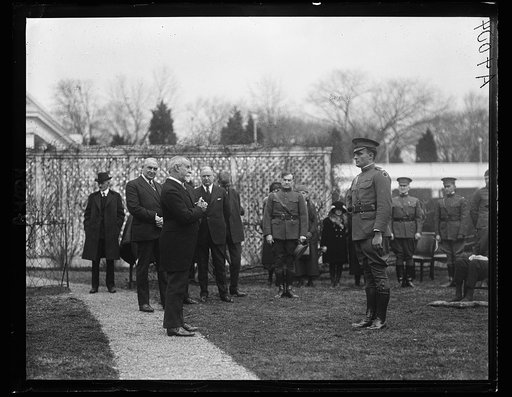 Ceremony outside White House with wounded soldier; Warren Harding at left. Washington, D.C.