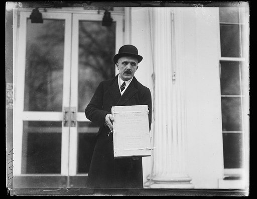 Man at White House, with book: "VII. Slet Vsesokolsky, V Praze 1920, VII Sokol Congress, Prague, Cxechoslovakia, 1920" Washington, D.C.