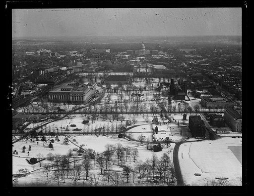 Aerial view looking toward U.S. Capitol with snow, Washington, D.C.