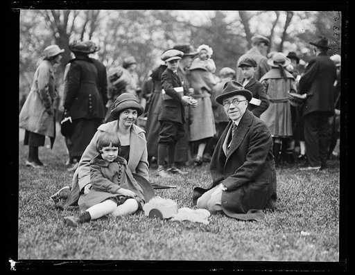 Family group sitting on grass