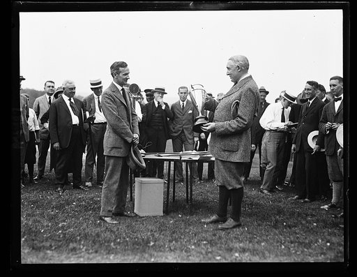 Group with Warren G. Harding holding trophy