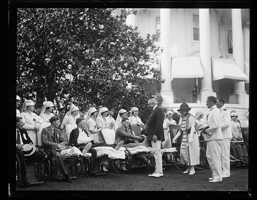 Pres. and Mrs. Harding shaking hands with veterans at White House garden party [Washington, D.C.