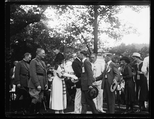 Pres. and Mrs. Harding shaking hands with soldiers [Washington, D.C.