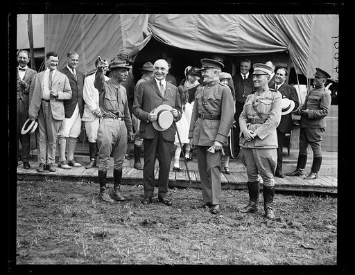 Reenactment of Pickett's Charge at the battle of Gettysburg in Pennsylvania. Smedley Butler, President Warren Harding, John J. Pershing, and John Archer Lejeune in front of canvas "White House"