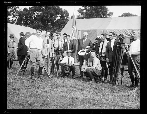 President Harding with group of photographers near tents