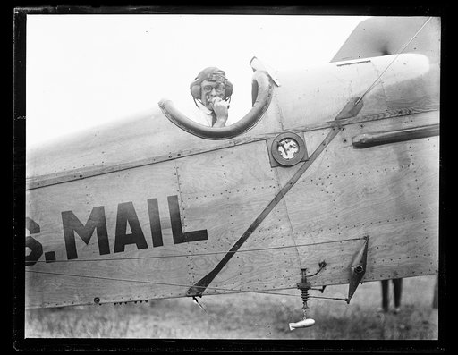Close-up of a Post Office Dept. mail plane equipped with the new experimental radio apparatus with which the Dept. hopes soon to make possible night flying. The little lead fish at the bottom of the picture is let out while flying and carries with it a long copper wire which serves as the antennae. 