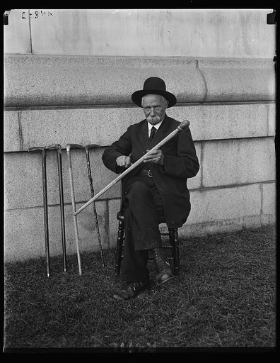 A. Buck of the Soldiers' Home carving the Lord's Prayer on walking canes. He has sold $2000 worth of these canes. Sept. 21, 1922