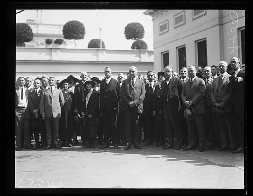 Warren Harding and group outside White House; includes Hubert Work to left of Harding. Washington, D.C.