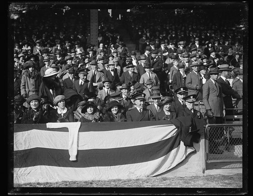 Spectators at ball field, including Admiral Wilson to right
