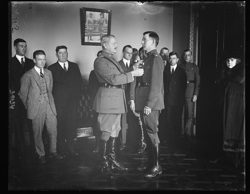 George E. Adamson, 1st. Lt. Quartermaster Corps, receiving Distinguished Service Cross from Gen. Pershing for his work as Confidential Secy. to Commander-in-Chief of the Amer. Expeditionary Forces and later to the Gen. of the Armies
