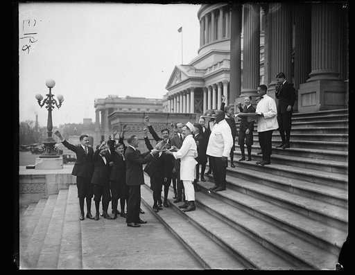 Group with roasted turkeys on steps of U.S. Capitol, Washington, D.C.