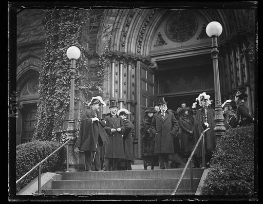 Secy. and Mrs. Hughes leaving St. Patrick Church where he attended memorial mass for assassinated Pres. of Poland