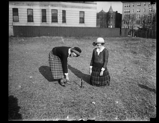 Debutantes playing horse shoes. Left to right: Emma Stitt, Virginia Edwards