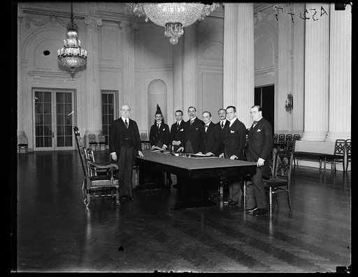 Group at table; Charles Evans Hughes, left