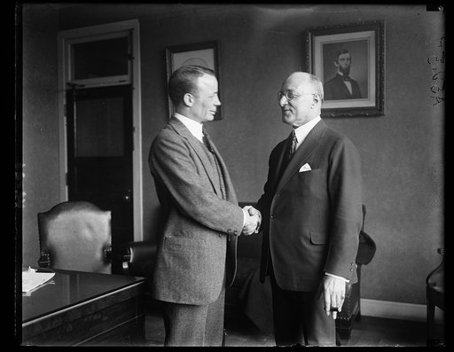 Col. Theodore Roosevelt, Asst. Secy. of the Navy (left), congratulating A.M. Loeb, pres. of the Nat'l Council Traveling Salesmen Assoc. upon the decision of Interstate Commerce Commission relating to the interchangeable mileage books. Roosevelt is Chmn. of the Associate Membership Div.