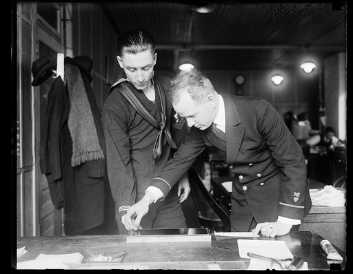 John A. Shaw taking fingerprints of Arthur G. Whaley, Coast Guard hdqtrs., Wash. D.C. The system keeps outcasts from other services from changing their names and enlisting and also establishes identity for men who have lost proof of service