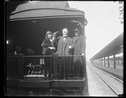 On back of train; Joe Cannon, center
