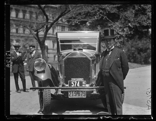 Amb. Hanihara in front of auto showing "diplomatic" sign