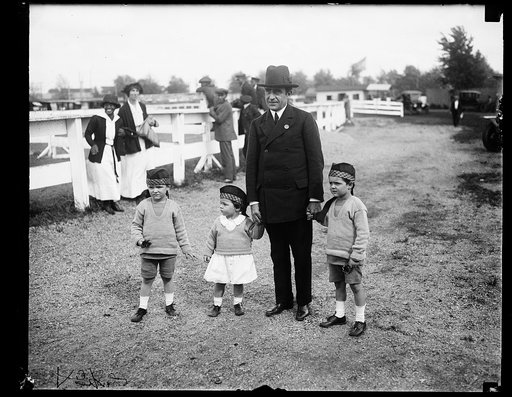Man with children at horse event?