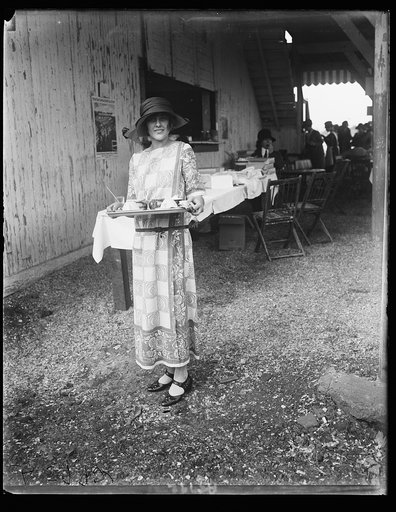 Evelyn Wadsworth, daughter of Senator and Mrs. Wadsworth of N.Y., serving cold drinks at Nat'l Capitol horse show
