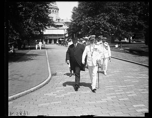 Edwin Denby and Admiral Henry Wilson, U.S. Naval Academy chapel in background, Annapolis, Maryland