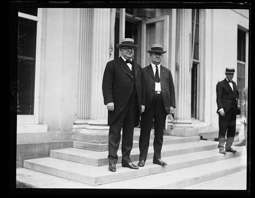 Col. T.W. Meekins, left, of Elizabeth City, N.C., and Hon. W.G. Branham, State Chmn. of Repub. Nat'l Comm. of N.C., right. asked Pres. Coolidge to receive a delegation from Durham on Aug. 23. The delegation will ask him to speak at dedication of site recently purchased where Johnson surrendered to S