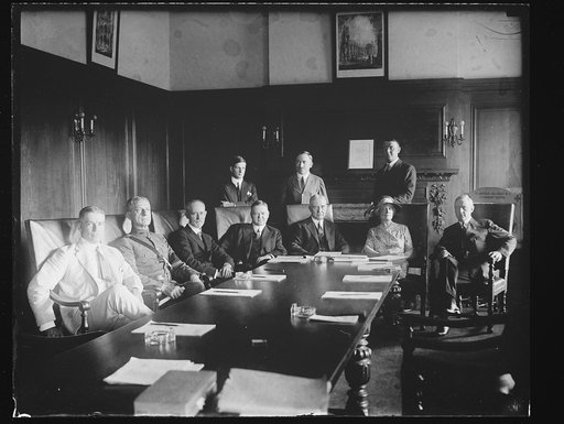 Group at table; includes Herbert Hoover